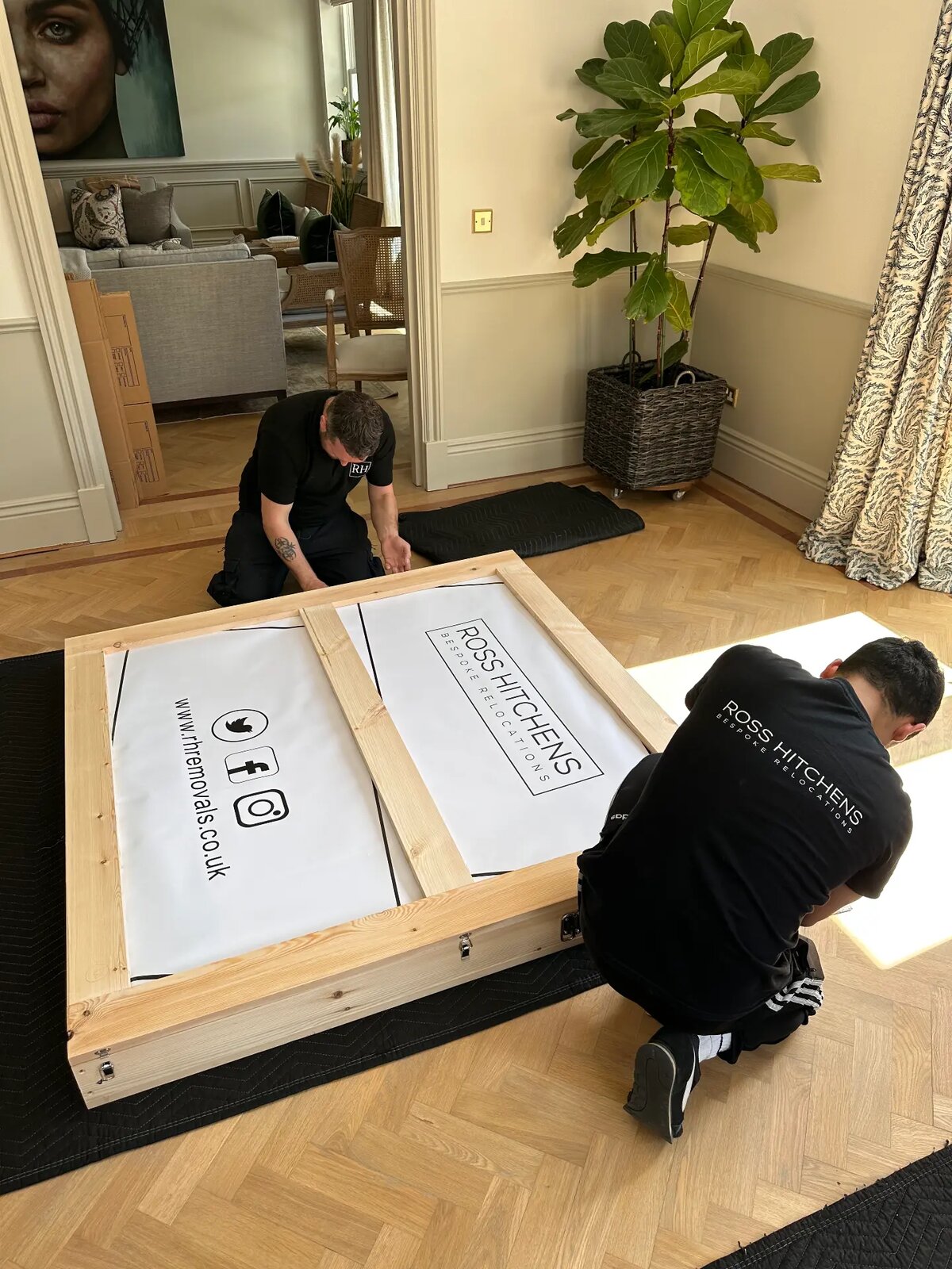 RH team building bespoke crates in the same living room during the move
