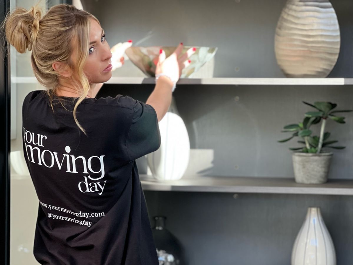 Your Moving Day team member arranging shelves in a client's new home