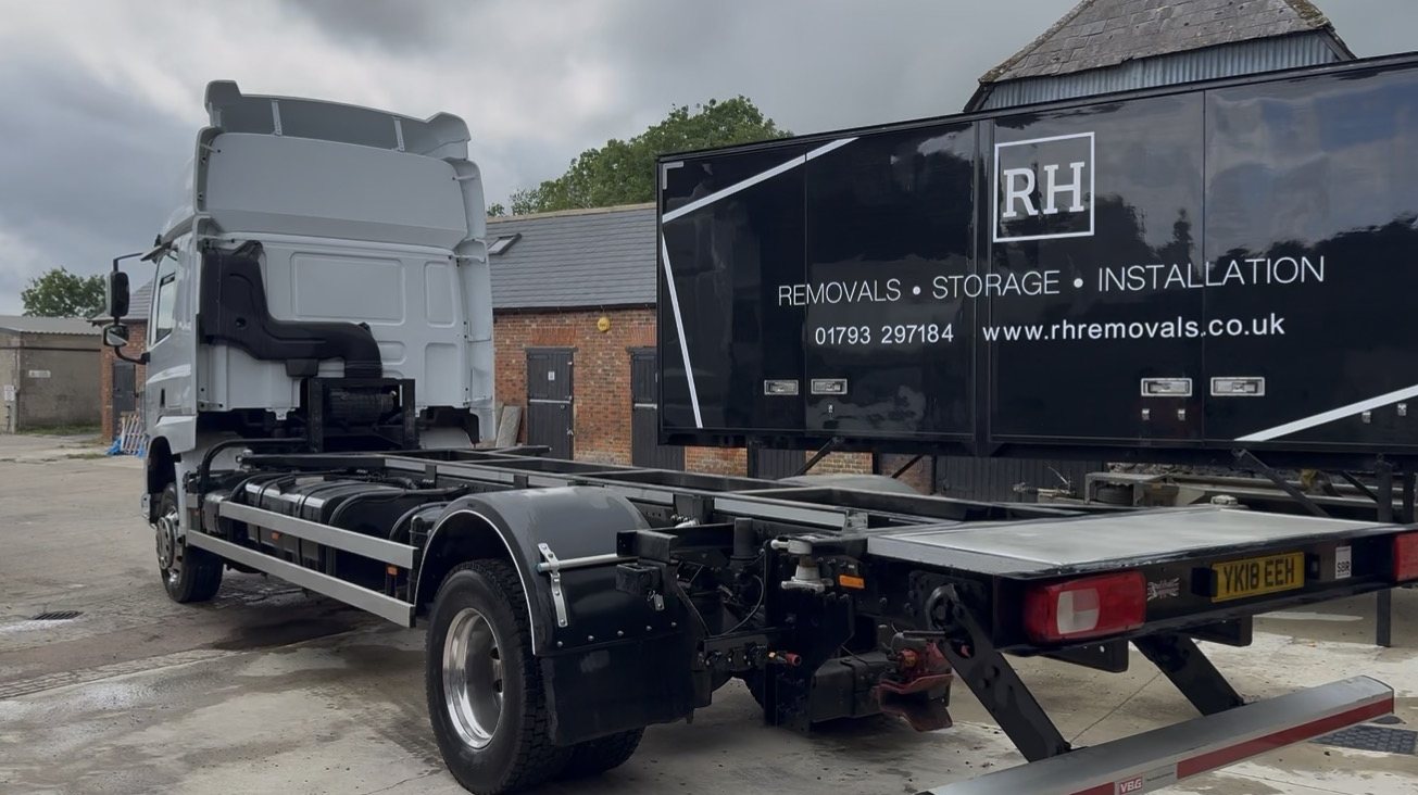 RH lorry ready to collect a de-mount removal body in the yard
