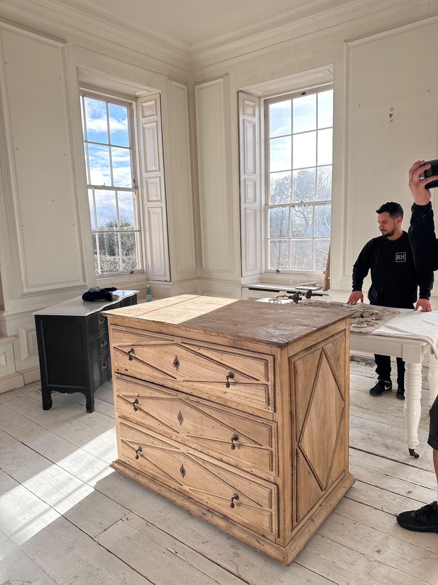 RH team placing an antique chest of drawers in a panelled period room