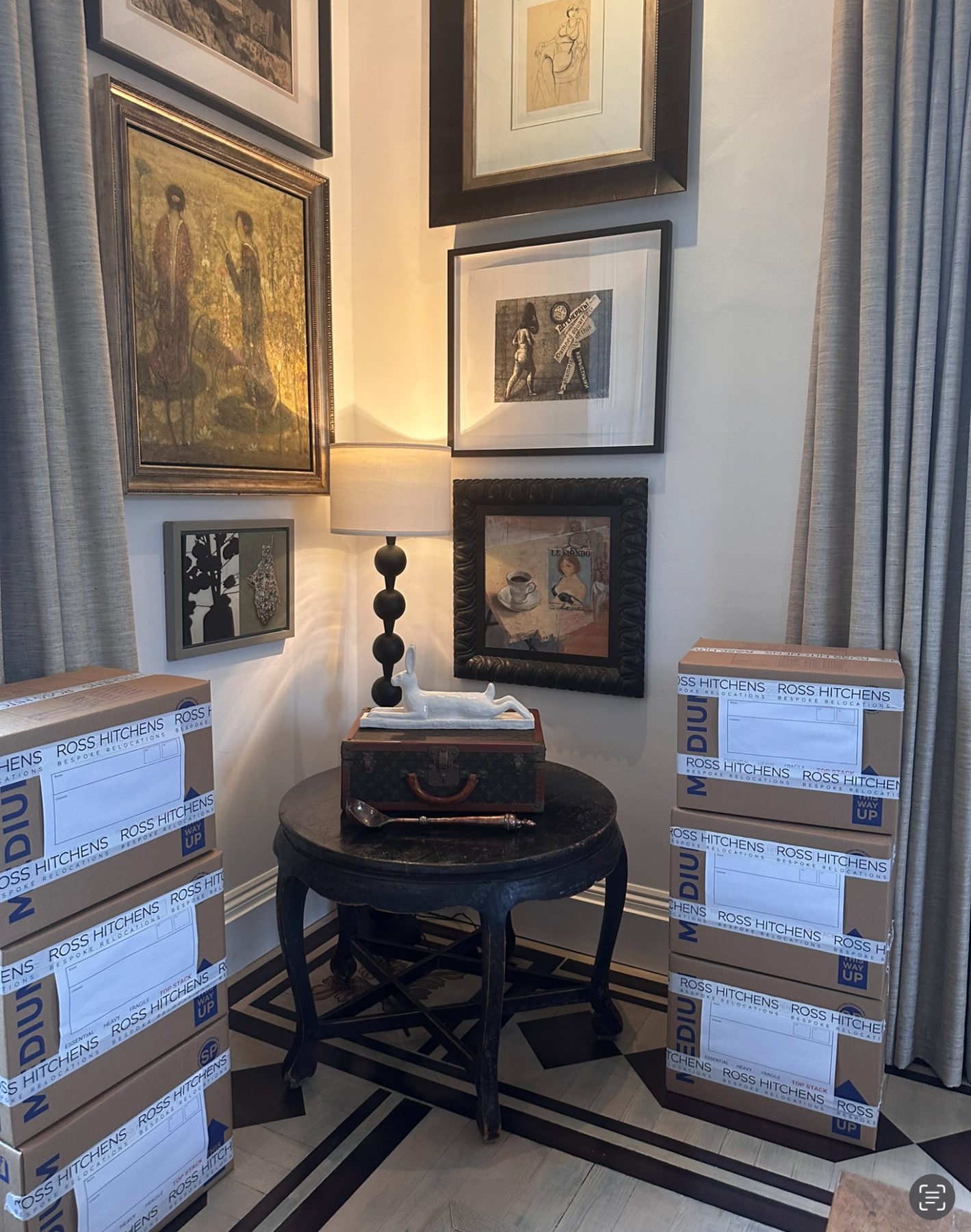 Packed RH cartons beside antiques and framed pictures