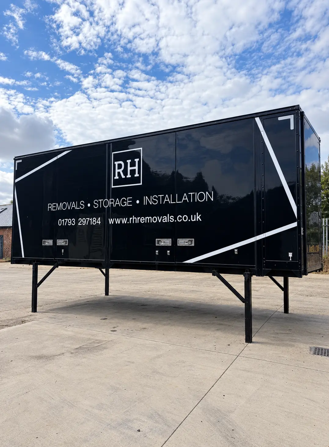 A black RH de-mount removal body standing on its own legs in the yard