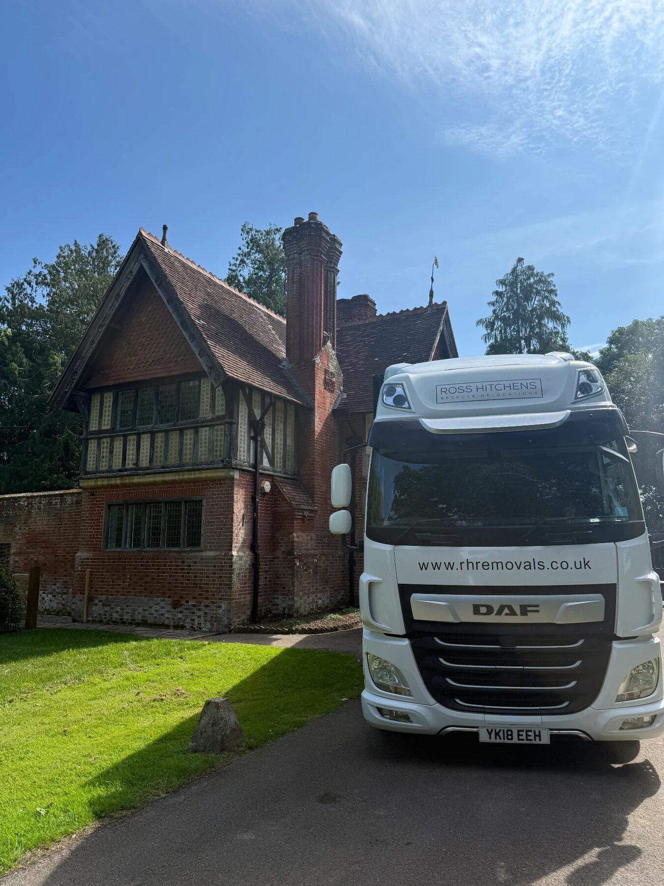 RH lorry on the drive of a period brick house