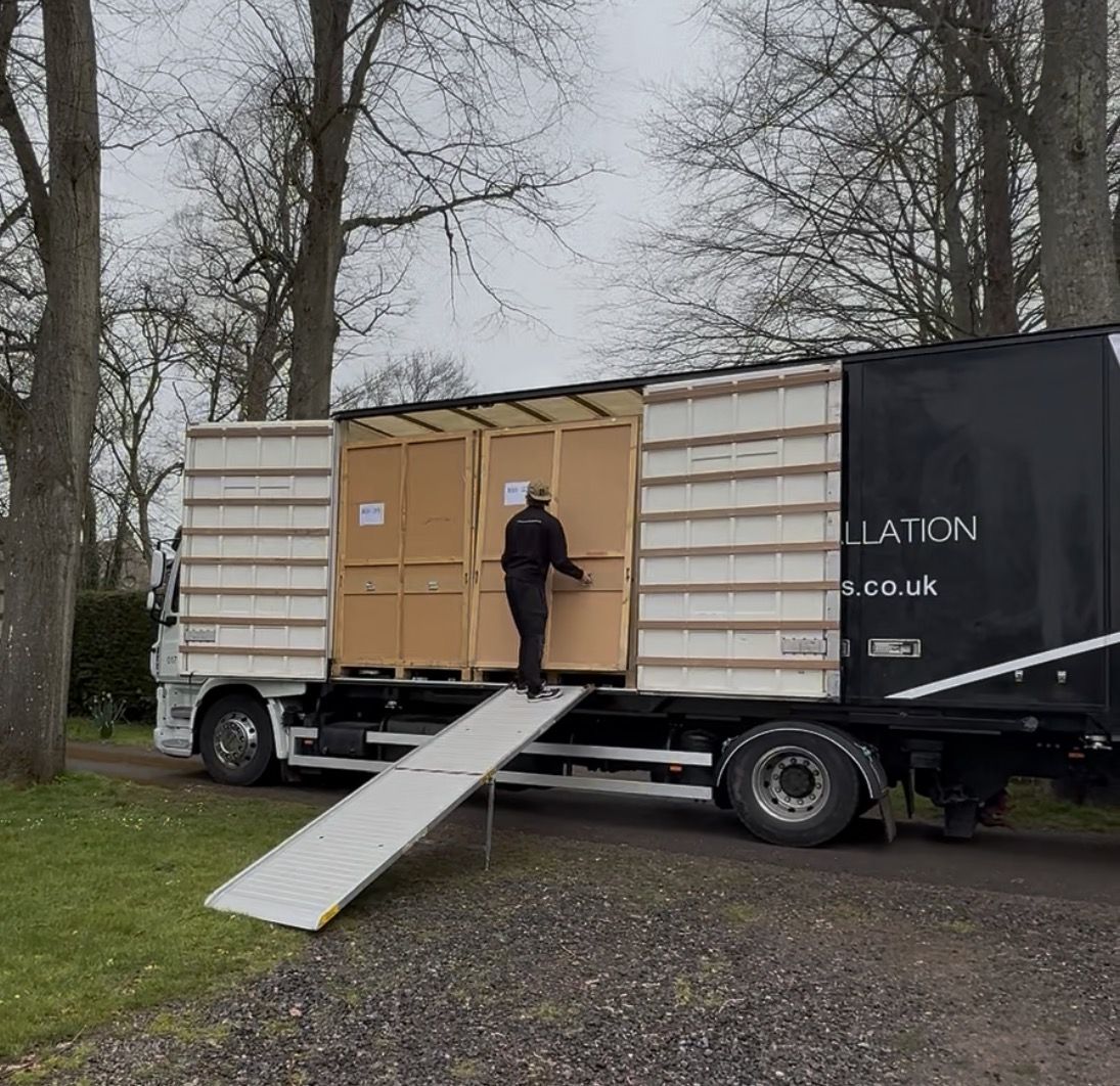 Wooden storage containers being loaded onto an RH lorry