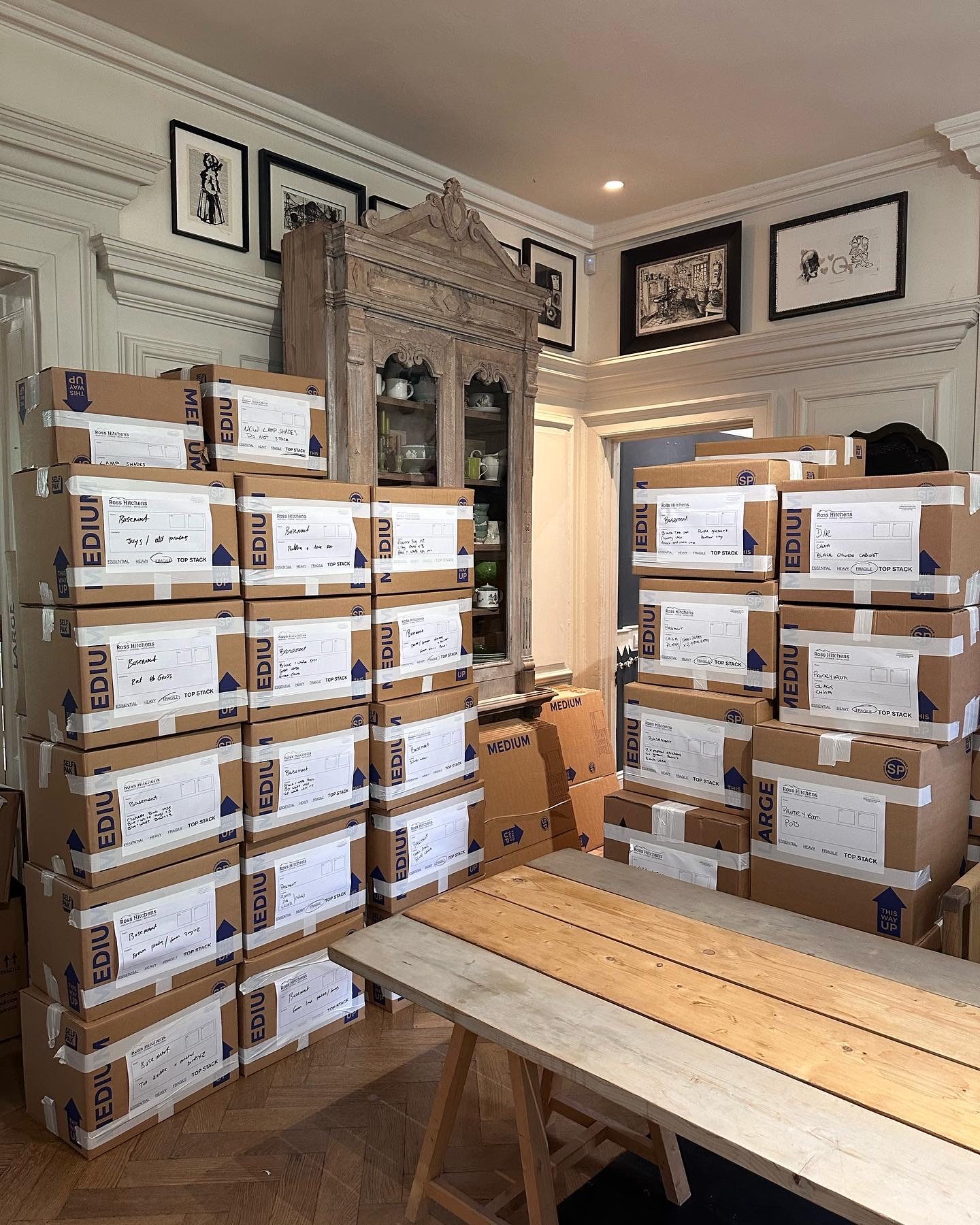 Packed and labelled RH cartons stacked in a period drawing room