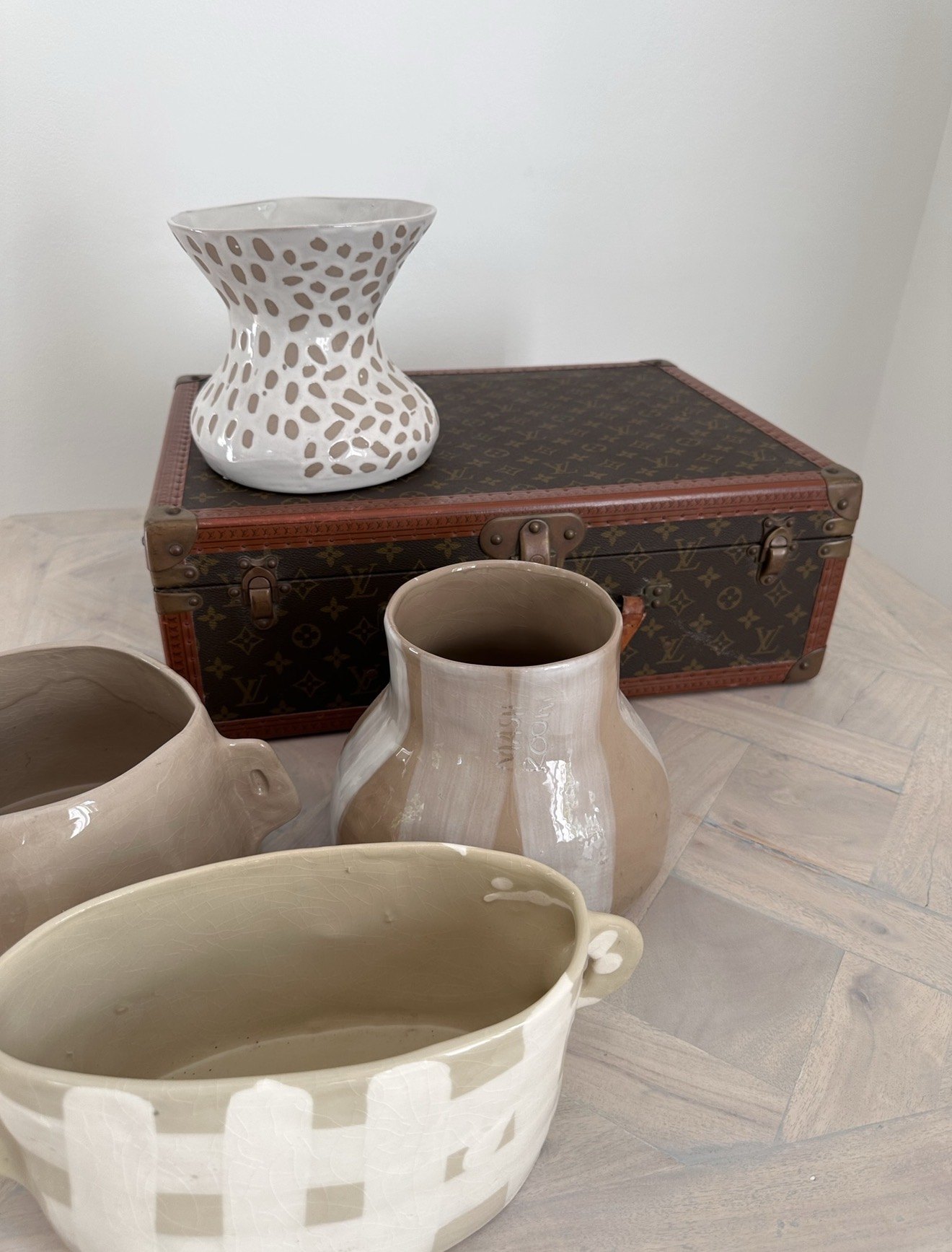 Ceramic vases and a vintage trunk unpacked for an interior scheme