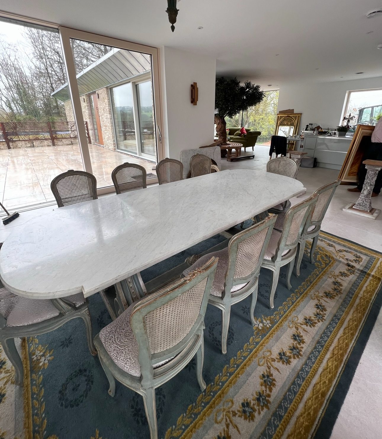 A marble dining table and chairs placed by RH in a new home