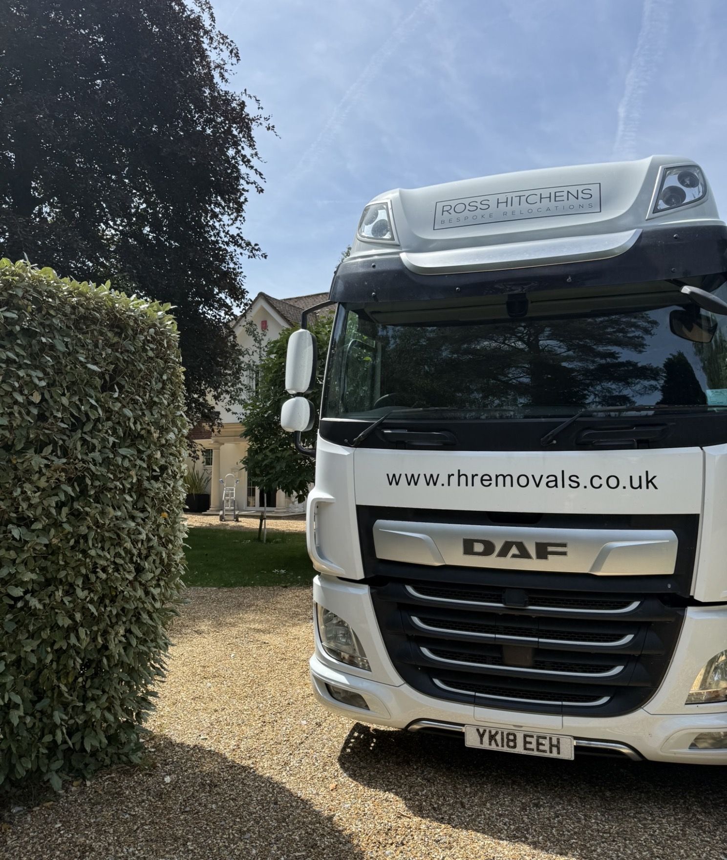 RH Removals lorry on the drive of a large house