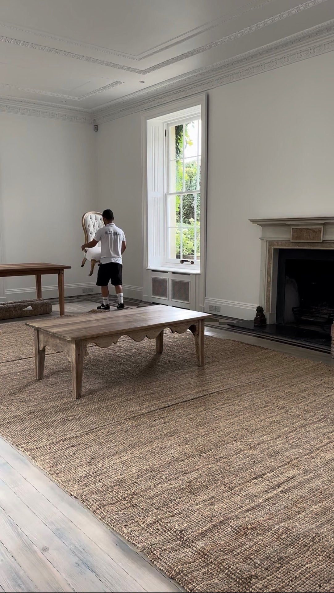 RH team member placing a chair in an empty period drawing room