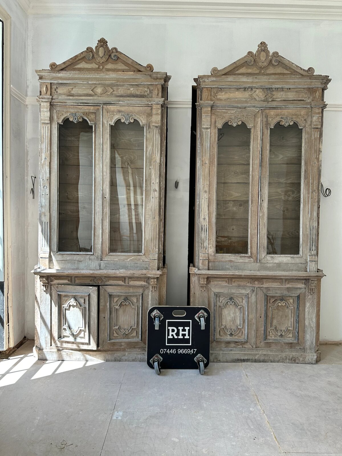 A pair of tall antique cabinets delivered and placed by RH